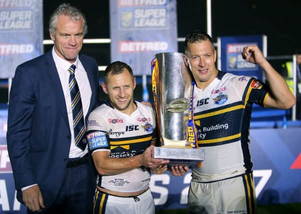 Leeds Rhinos coach Brian McDermott, Rob Burrow and Danny McGuire celebrate with the trophy after the final whistle. PIC: PA