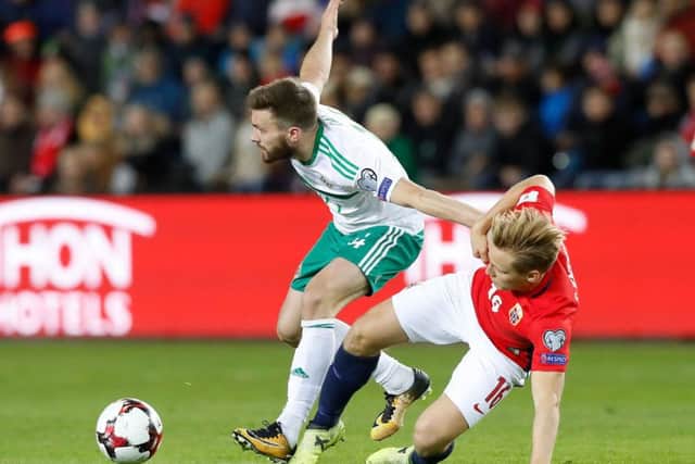 Northern Ireland's Stuart Dallas (left) and Norway's Jonas Svensson battle for the ball (Picture: Martin Rickett/PA Wire)