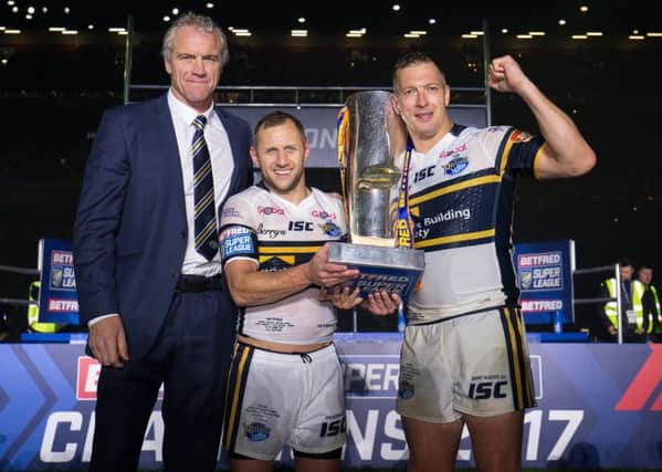 Danny McGuire, Rob Burrow and head coach Brian McDermott celebrate with the Super League trophy.
