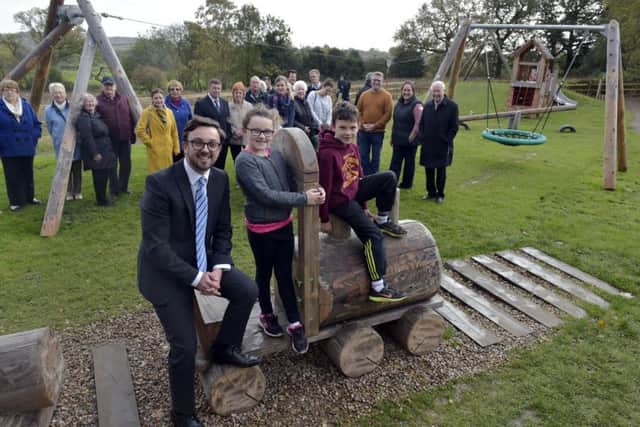 Councillor Matthew Robinson (Harewood Ward)   opening the new Scarcroft childrensplayground pictured with Elodie, eight, and Harry, seven McLaughlibn from Scarcroft