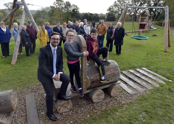Councillor Matthew Robinson (Harewood Ward)   opening the new Scarcroft childrensplayground pictured with Elodie, eight, and Harry, seven McLaughlibn from Scarcroft