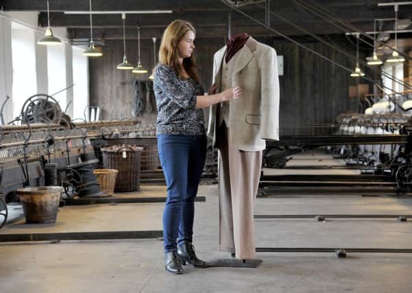 Amy Jenkinson, assistant curator of industrial history, puts the finishing touches to the suit at Leeds Industrial Museum