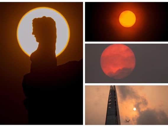The red sun created some stunning views across Yorkshire and the country today.
The main image on the left from The Yorkshire Post photographer James Hardisty shows the red sun silhouetting one of the 17th Century Wildmen stone-carved figures on Monk Bar, York.