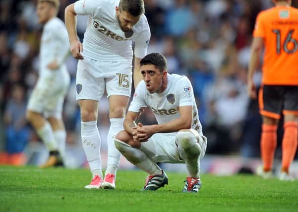 CHIN UP: Stuart Dallas consoles Pablo Hernandez after missing a late penalty in the 1-0 defeat to Reading at Elland Road on Saturday. Picture: Tony Johnson.