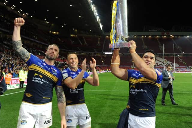 Kylie Leuluai holds the Super League trophy aloft in 2015 along with Jamie Peacock and Kevin Sinfield.