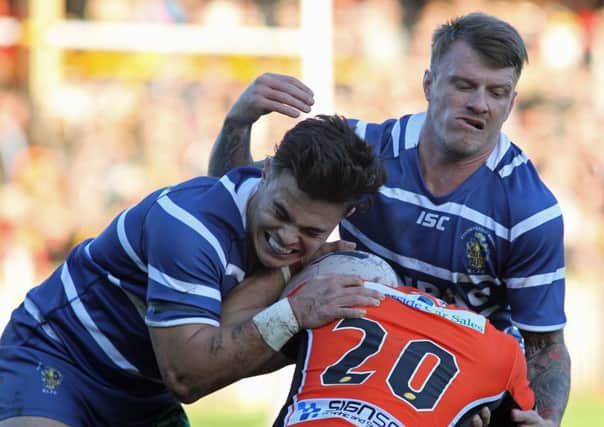 Featherstone's Michael Channing and Jamie Thackray double up on Castleford's Jy Hitchcox during the Boxing Day game between the sides in 2015.