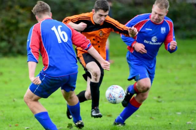 Matt Windle and Matt Hutchinson, of Battyeford, close in on Old Bank's Jonny Mitchell. PIC: Paul Butterfield