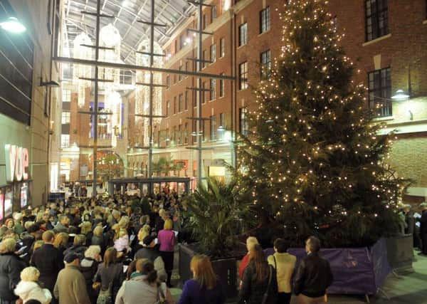 Past year: Members of the public singing carols around the lit Chritmas Tree at the Yorkshire Evening Post Half and Half Appeal's  Light Up A Life at The Light in Leeds.