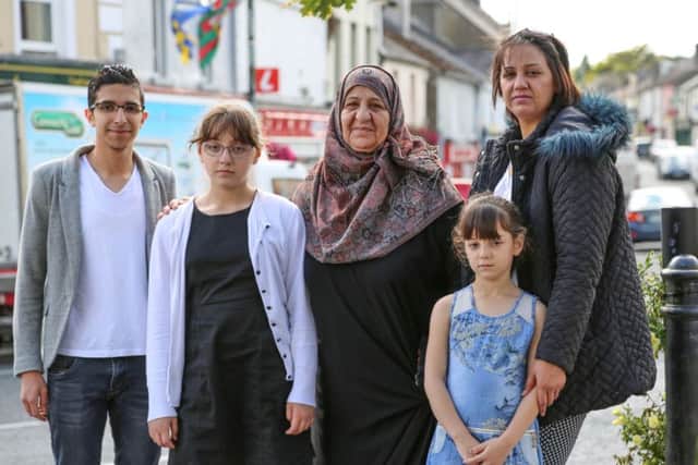 EAST MEETS WEST: From left to right, Ghassan, Ahlam, Seeham, Jenan and Judy on the streets of Ballaghaderreen in western Ireland in Hotel for Refugees.