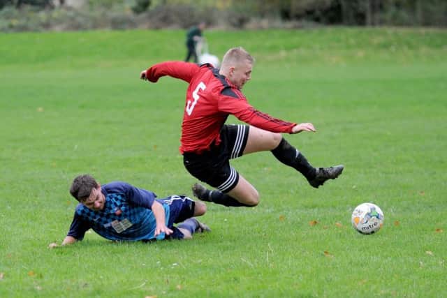 Tom Jukes, of Sky Blue, attempts to tackle Rothwell's Ryan Askin. PIC: Steve Riding