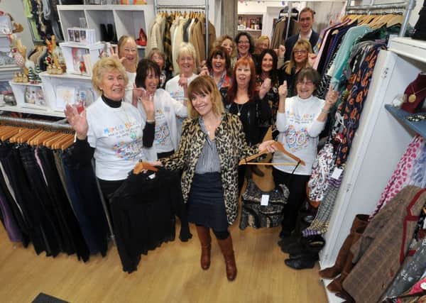 Emmerdale actress Zoe Henry opens the refurbished Martin House charity shop on Yeadon High Street. Pictured with volunteers.  Picture Tony Johnson.
