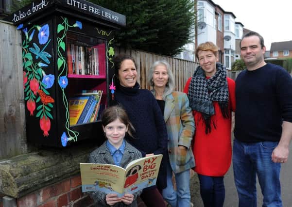 Carry Franklin founder of Leeds Little Free Library, with artist Jacky Fleming  and  home owners Monica  and Luke Dickson and daughter Greta, seven  at the new library on Landseer Grove, Bramley.