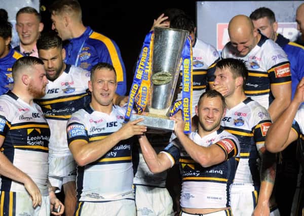 DREAM TEAM: Danny McGuire and Rob Burrow lift the Super League trophy at Old Trafford last month.  Picture: Bruce Rollinson