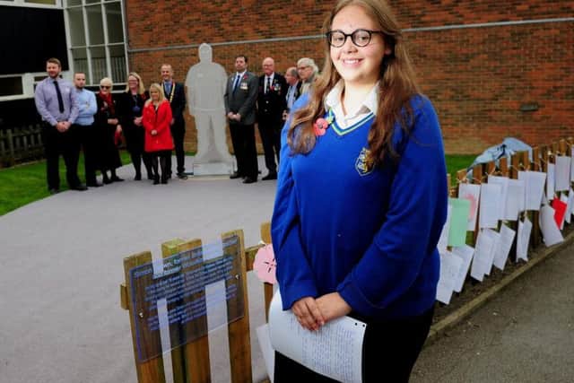 Year 10 pupil Emily Berry, pictured by the statue that war veteran Simon Brown has donated to Woodkirk Academy, in Tingley. Picture: Simon Hulme.