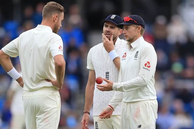 HELPING HAND: England's captain Joe Root (right) talks to Stuart Broad (left) and James Anderson, centre. Picture: Nigel French/PA