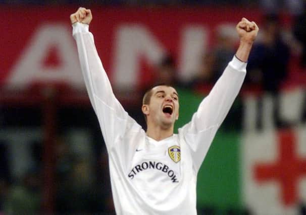 Dominic Matteo celebrates Leeds United's result at AC Milan's San Siro ground.