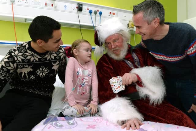 SPECIAL DELIVERY: Cbeebiess Alex Winters and Ben Cajee with Santa and Ellouise Travers, 6.