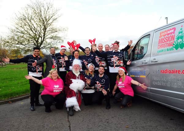 FESTIVE SPIRIT: Radio Aire presenters and staff celebrate the launch of Mission Christmas. PIC: Simon Hulme