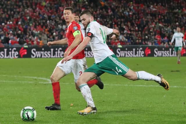 Switzerland's Stephan Lichtsteiner (left) and Northern Ireland's Stuart Dallas battle for the ball during the FIFA World Cup Qualifying second leg match at St Jakob Park, Basel. PIC: Niall Carson/PA Wire