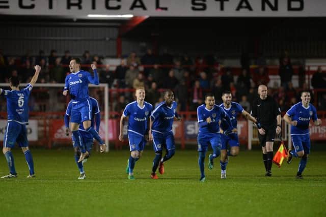 Guiseley celebrate winning the penalty shootout.