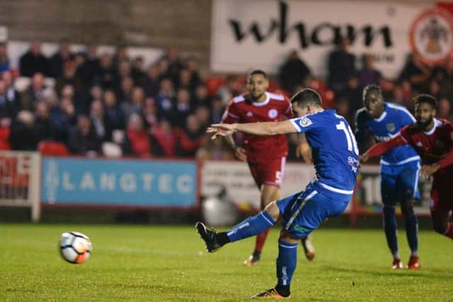 Substitute John Rooney scores Guiseley's equaliser from the penalty spot.