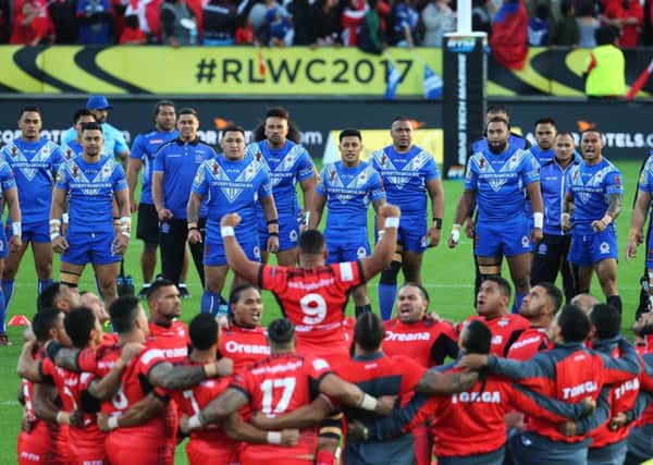 Samoa (blue) have been fortunate to reach the knockout phase of the RL World Cup but Tonga (foreground) have lit up the tournament. PIC: John Cowpland/SWpix.com/PhotosportNZ