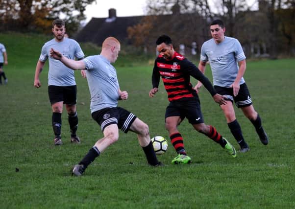 GO ROUND: Stanley United's Leroy Watson takes on Stanningley OB's Dale McCormack. United won 3-0. Picture: Steve Riding
