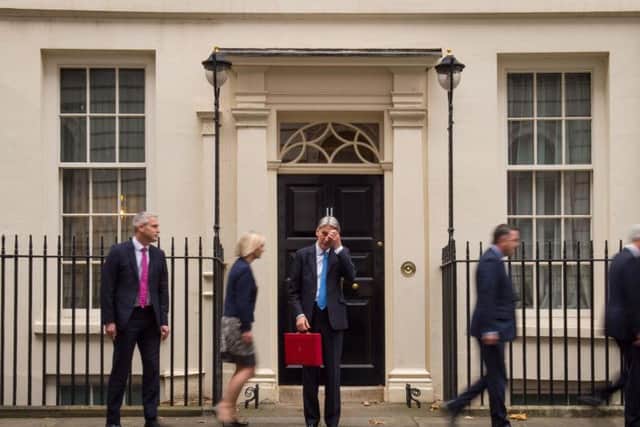 Chancellor Philip Hammond stands outside Number 11 Downing Street