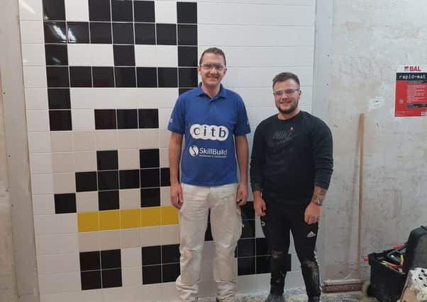 INTERIOR TREND: Steve Roberts and Callum Pearson with his tiled mural.