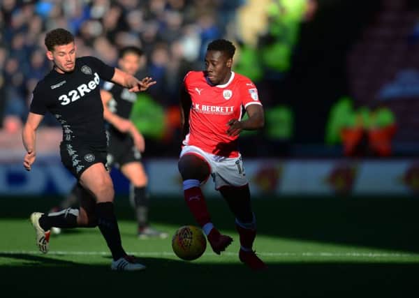 Kalvin Phillips and Barnsley's Andy Yiadom battle for the ball. PIC: James Hardisty