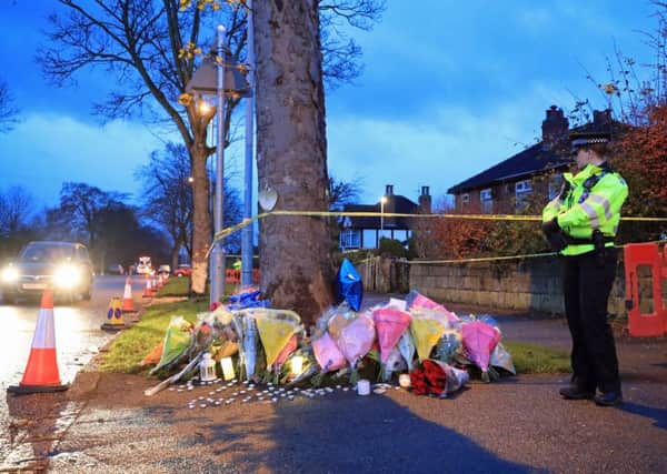 Floral tributes are left near the scene. PIC: PA