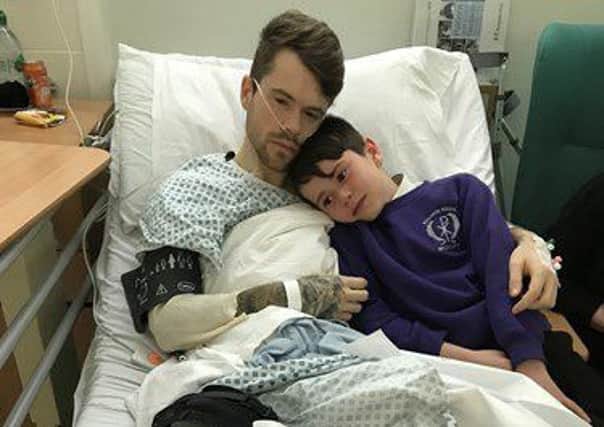 AGONY: Jamie Underdown is consoled by younger brother Mason.