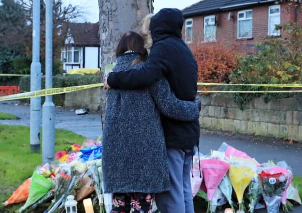 A woman, thought to be the mother of one of the victims, looks at floral tributes close to the scene of a car crash in Stonegate Road, Leeds, that claimed the lives of five people, including three children. PRESS ASSOCIATION Photo. Picture date: Monday November 27, 2017. See PA story POLICE Leeds. Photo credit should read: Peter Byrne/PA Wire