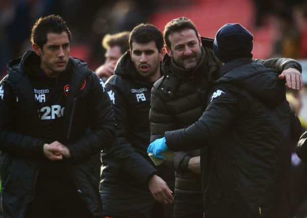 Thomas Christiansen celebrates with his staff after the Barnsley game.