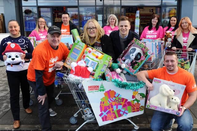DASH: Radio Aire Mission Christmas appeal. Breakfast show presenters Caroline and Ant with trolleys full of gifts outside B&M in Armley. PIC: Jonathan Gawthorpe