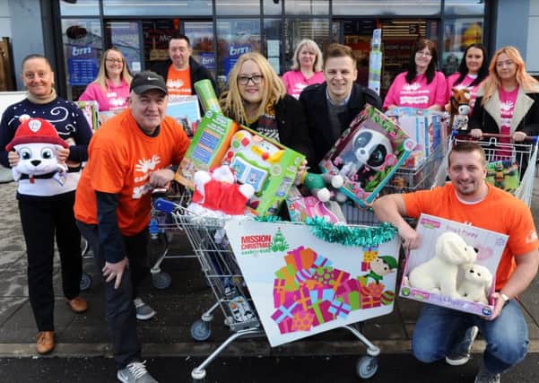 DASH: Radio Aire Mission Christmas appeal. Breakfast show presenters Caroline and Ant with trolleys full of gifts outside B&M in Armley. PIC: Jonathan Gawthorpe