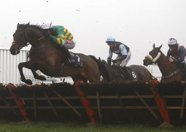 Unowhatimeanharry, ridden by Barry Geraghty clearing an early flight at Ascot last December. PIC: Julian Herbert/PA Wire