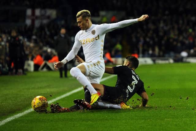 Gjanni Alioski is tackled by Neil Taylor