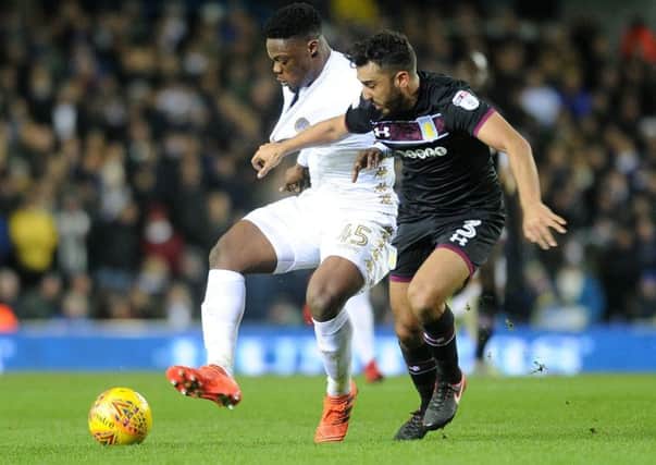 LEADING THE LINE: Leeds United's Caleb Ekuban, left, pictured challenging Aston Villa's Neil Taylor. Picture by Jonathan Gawthorpe.