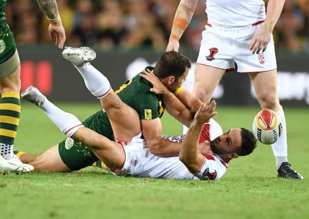 CRUNCH: England's Luke Gale is tackled hard at the Suncorp Stadium. Picture: Gregg Porteous/NRL Imagery/PA