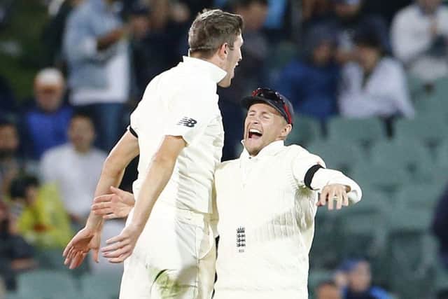 England's Craig Overton celebrates with Joe Root after he took the wicket of Steve Smith. Picture: Jason O'Brien/PA