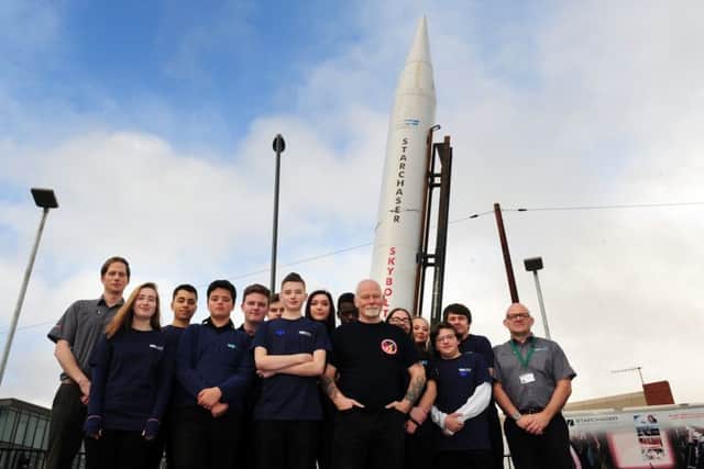 ROCKET MAN: Steve Bennett (centre) with students and staff in front of the Skybolt Rocket.