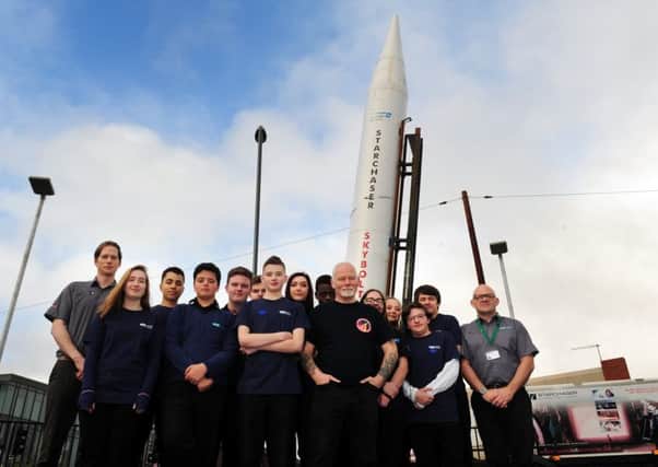 ROCKET MAN: Steve Bennett (centre) with students and staff in front of the Skybolt Rocket.