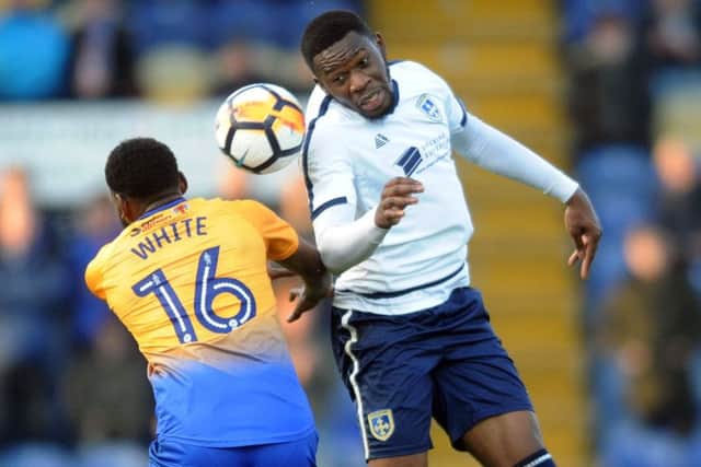 Guiseley's Mike Fondop-Talom takes on Mansfield's Hayden White. PIC: Jonathan Gawthorpe
