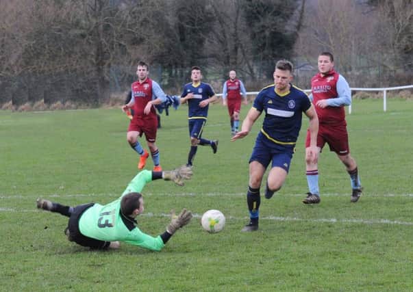 Toby Harris, of Ilkley Town  is beaten on this occasion in the West Yorkshire League, League Cup by  Featherstone Colliery goalkeeper Ryan Smith. PIC: Steve Riding
