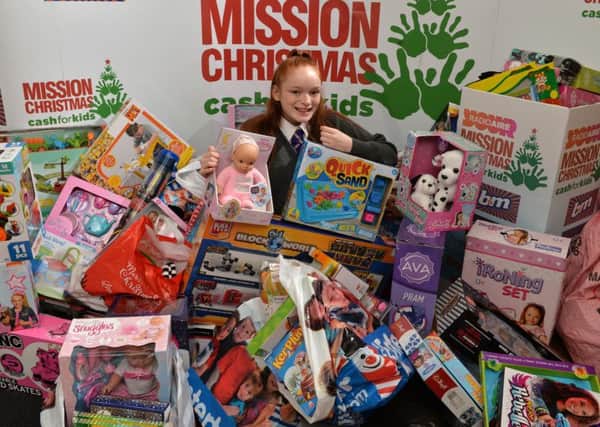 Leeds schoolgirl Kayleigh Glancy, 14, hands over presents to Radio Aire's Mission Christmas appeal for disadvantaged children she has bought with cash she earned from chores she's done throughout the year. Kayleigh has raised hundreds of pounds for Mission Christmas for a number of years.
4 December 2017.  Picture Bruce Rollinson