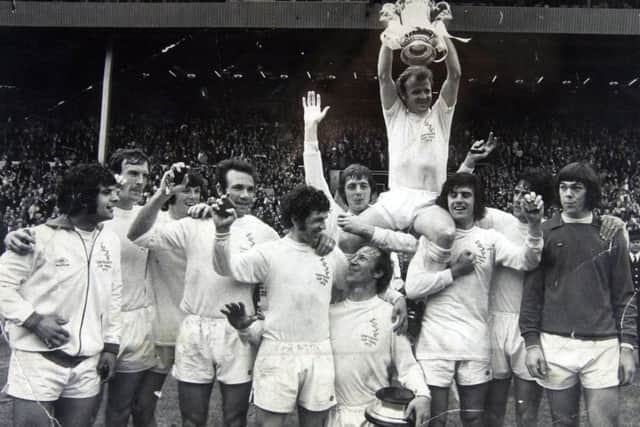 Billy Bremner lifts the FA Cup in 1973.