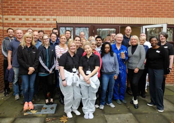 Employees from NestlÃ©  Professional and Orchard Care Homes, outside Paisley Lodge, in Leeds.