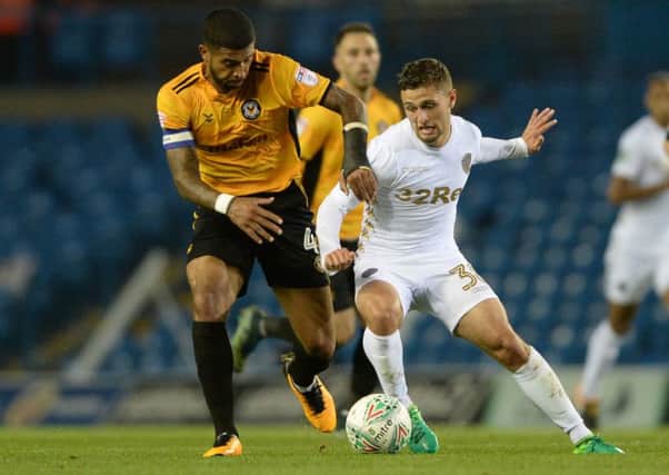 Joss Labadie and Eoghan Stokes challenge for the ball during the Carabao Cup, second round clash between Leeds United and Newport County at Elland Road.