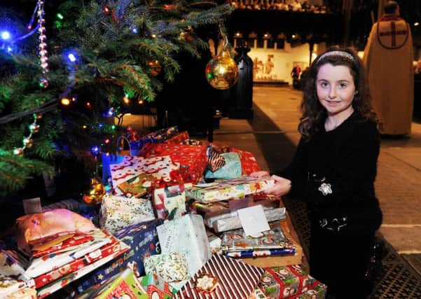 Seven-year-old Eimear Rose Langham from Morley with her presents ready to place under the tree. PIC: Jonathan Gawthorpe